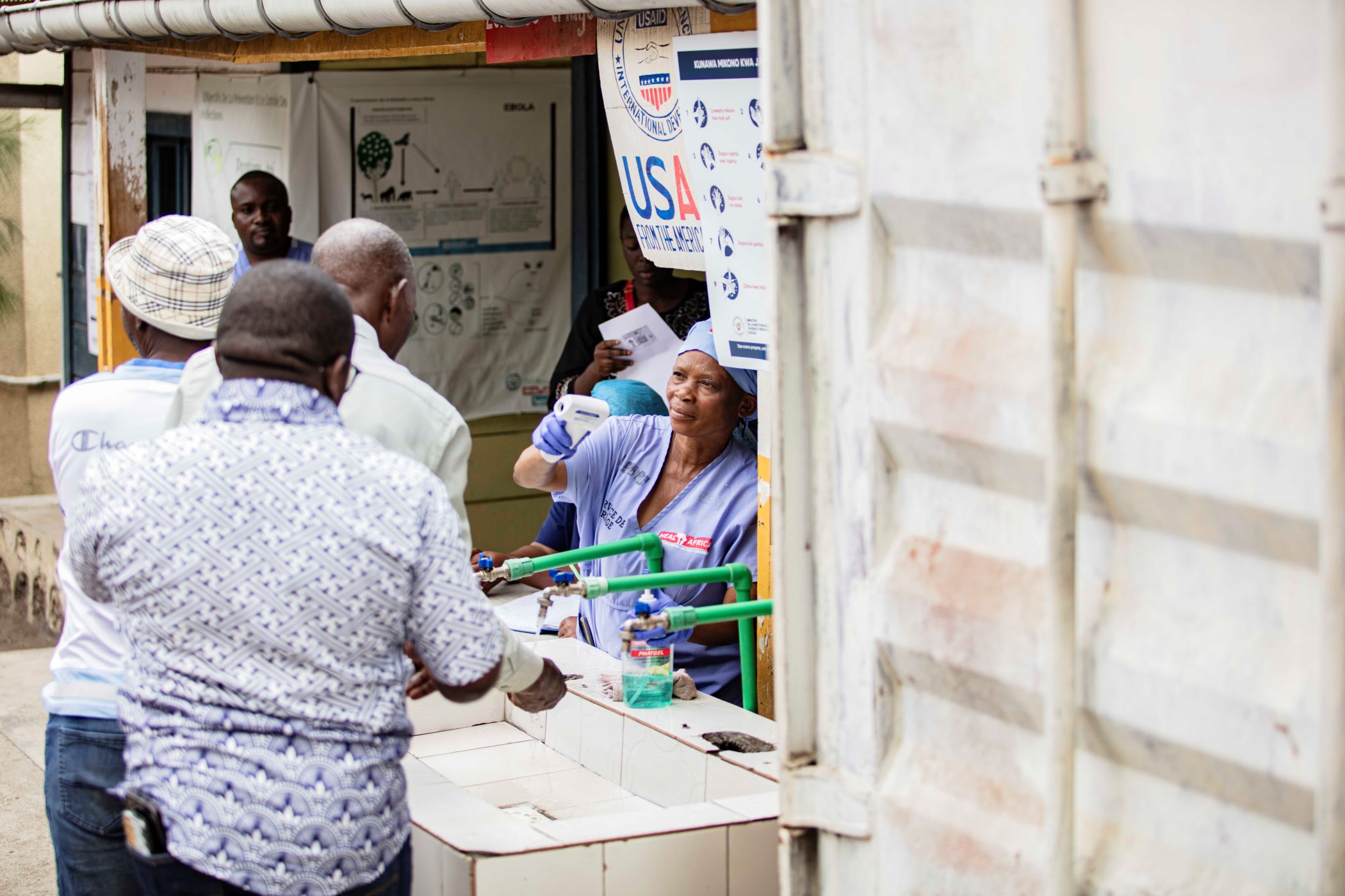 Nurses take temperature of those washing hands before entering hospital