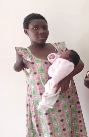 Young lady with one arm holding her baby