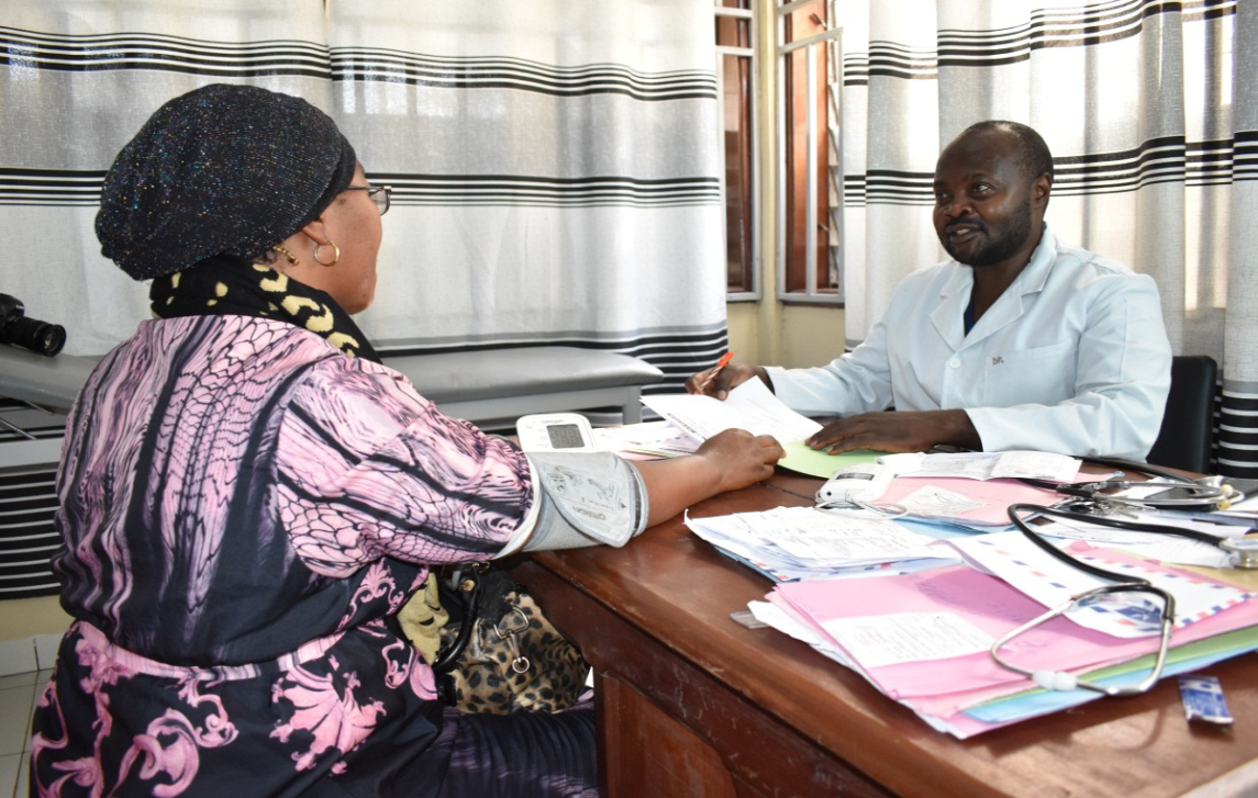 two people sitting in an office sharing documents 