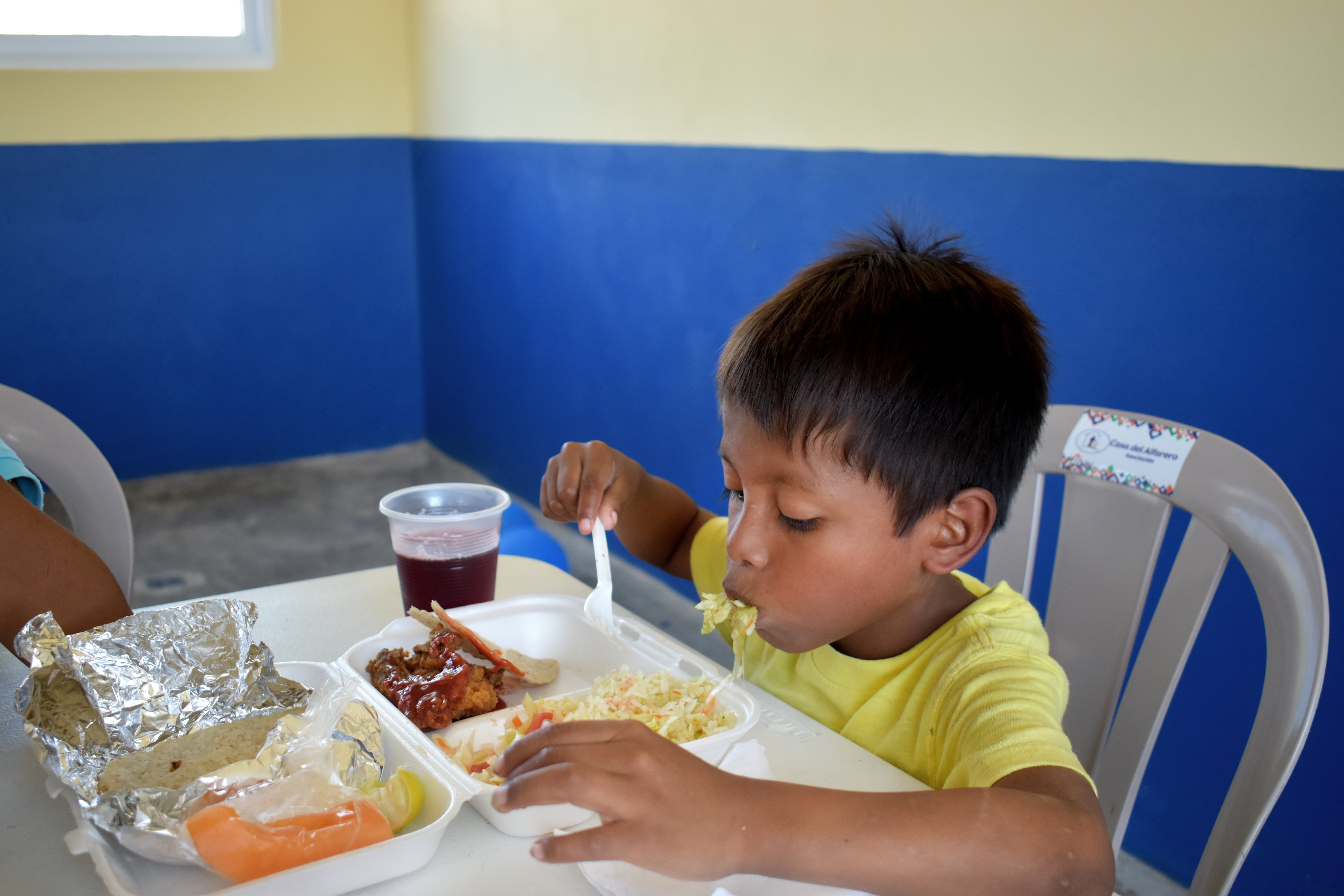 A young boy eating lunch 