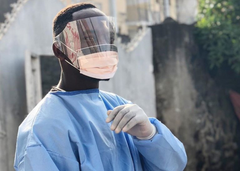 a medical professional wearing protective clothing looking at the camera 