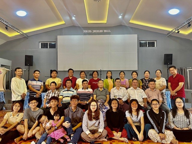 A group of people having their photo taken at church 