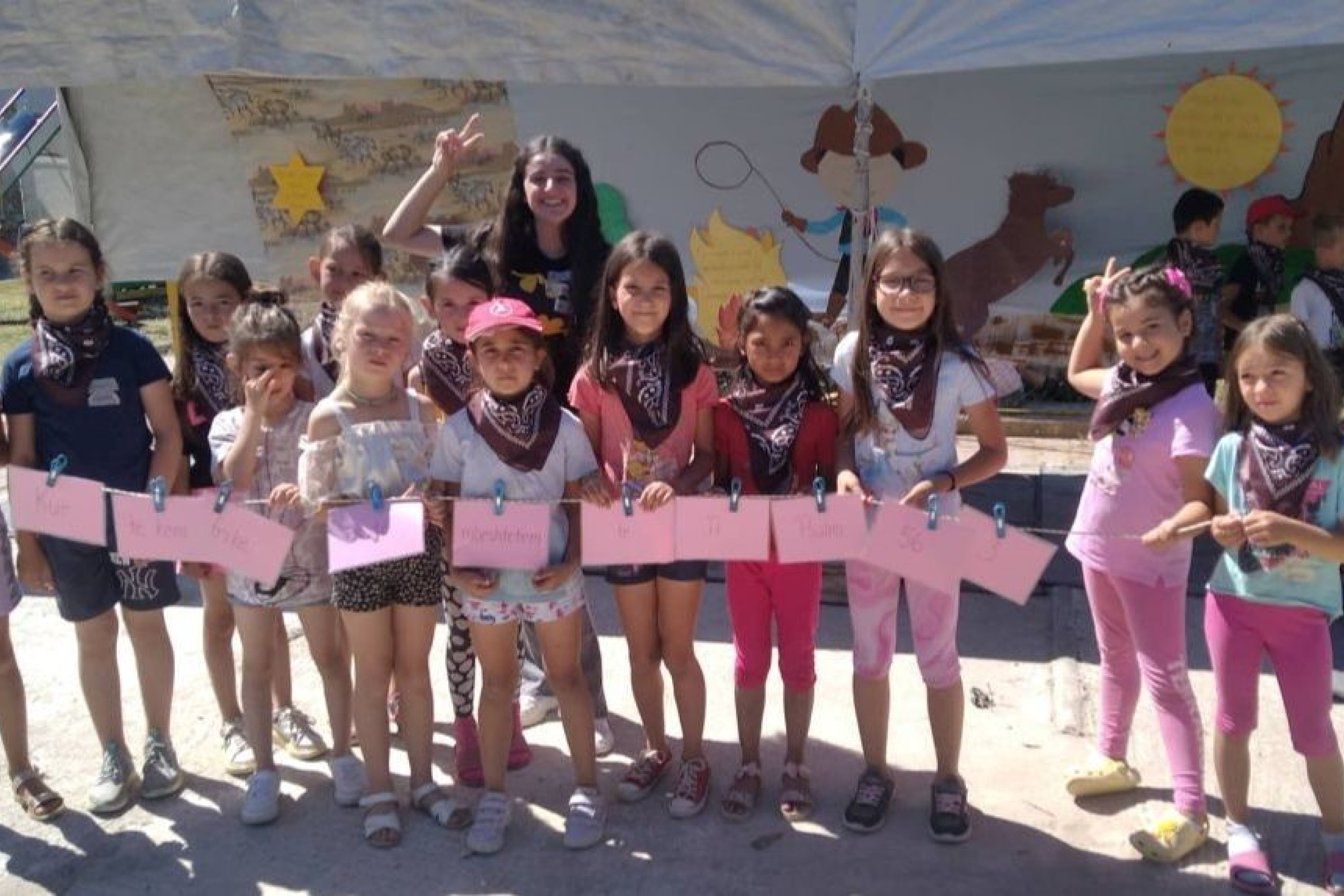 Holiday Bible camp in Albania - group of children gathered together showing off their artwork
