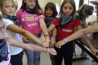 Holiday Bible camp in Albania - Group of children showing off colourful wristbands