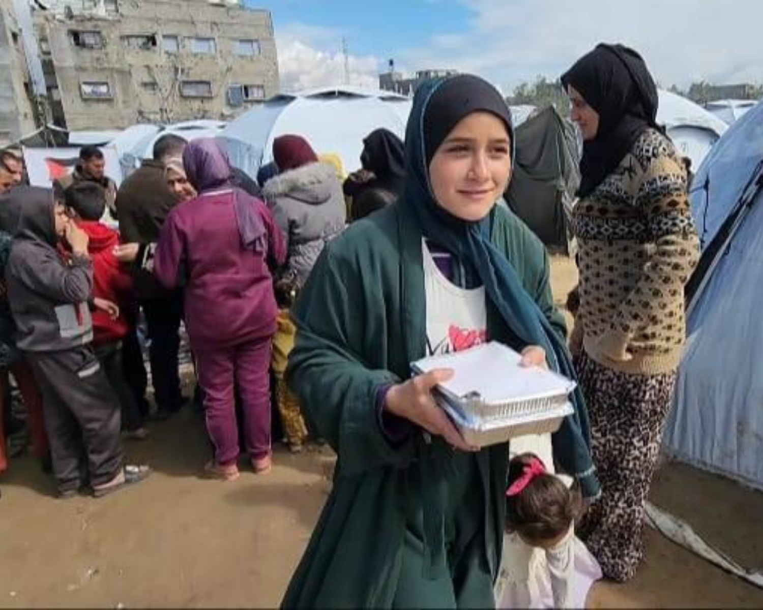 A large group of kids smiling for the photo. 