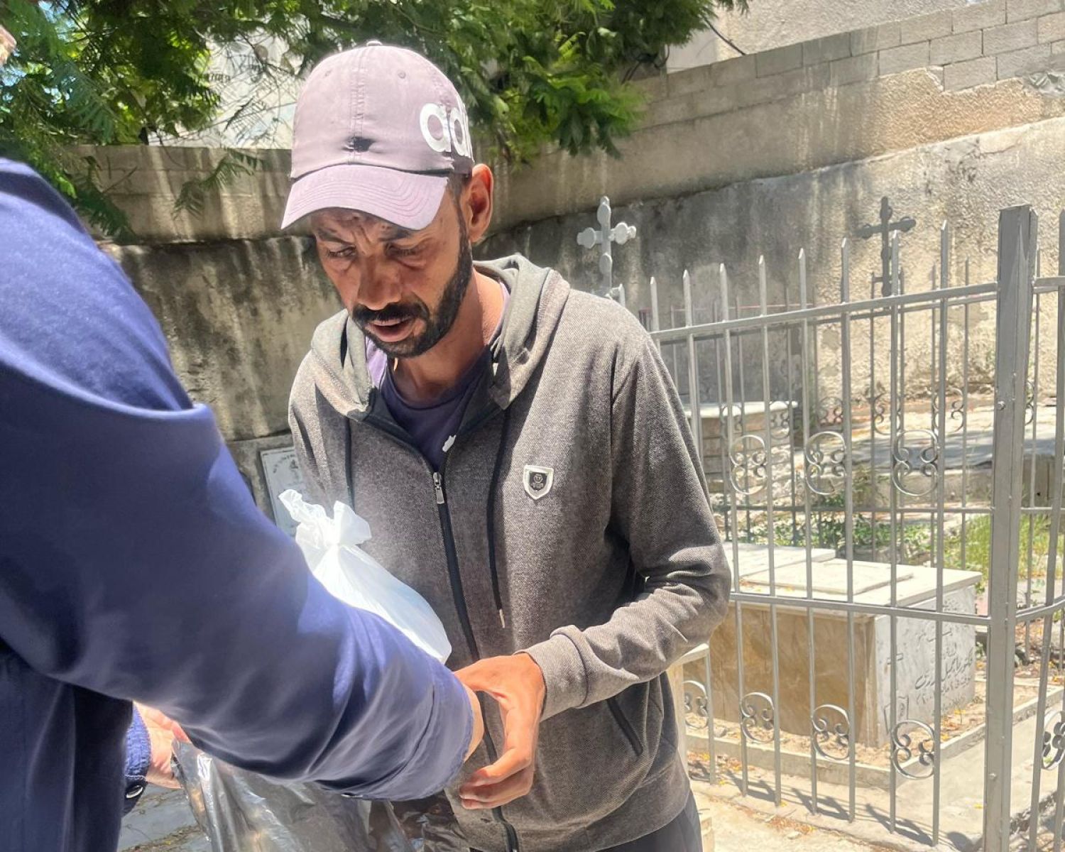A young girl with face paint on her cheek looking at the camera. 