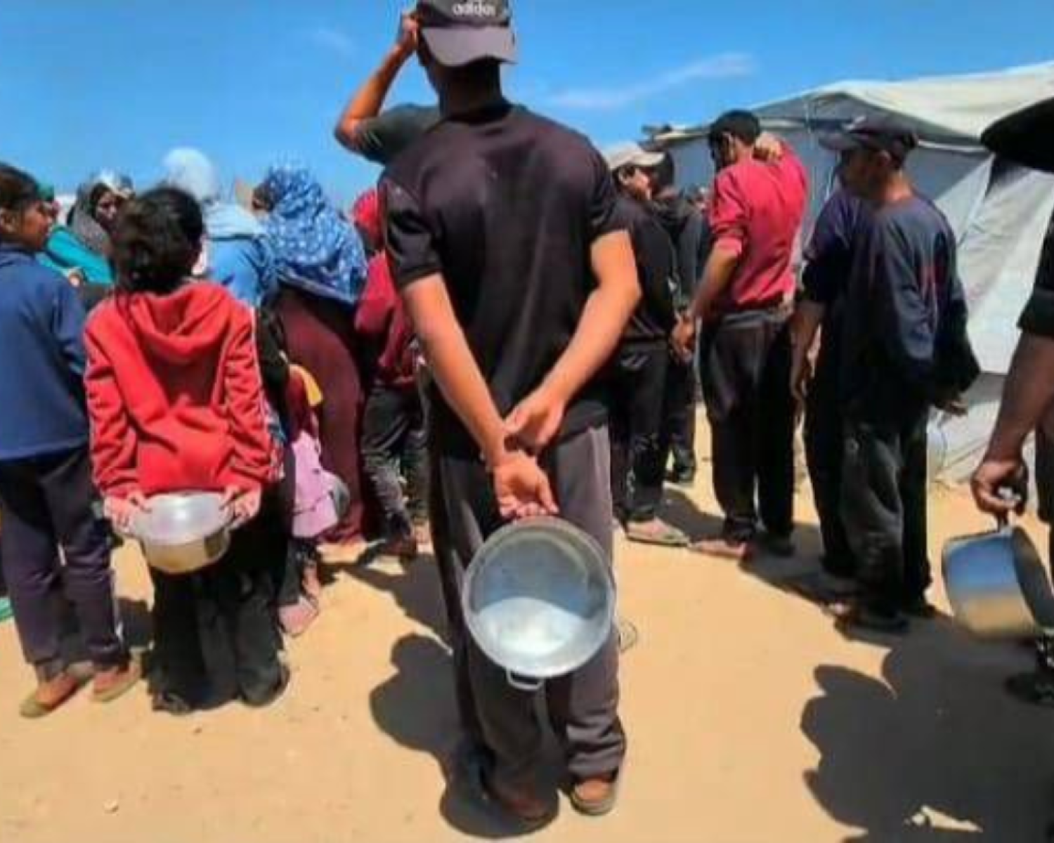 A young girl with face paint on her cheek looking at the camera. 