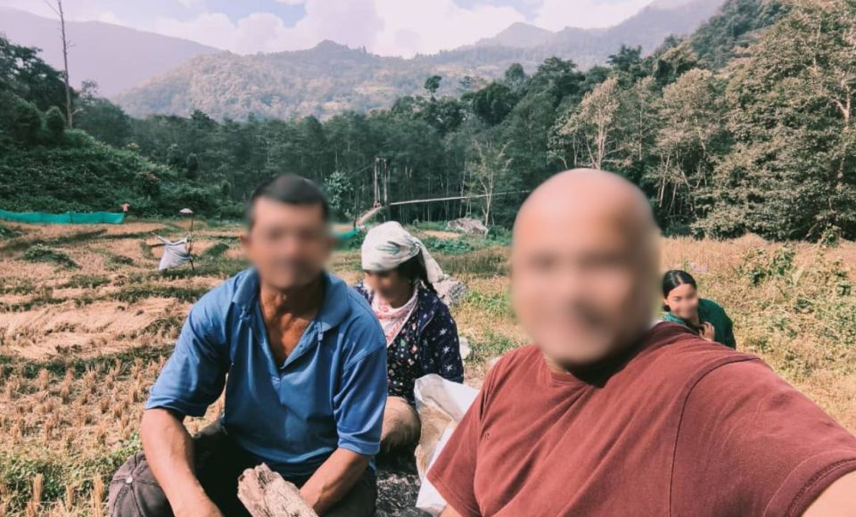 A group of people in a field in South Asia