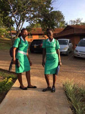 Two young ladies, smiling together for the photo.