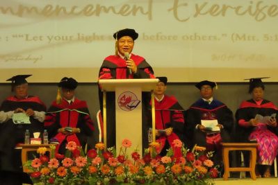 A teacher giving a speech at a graduation ceremony.