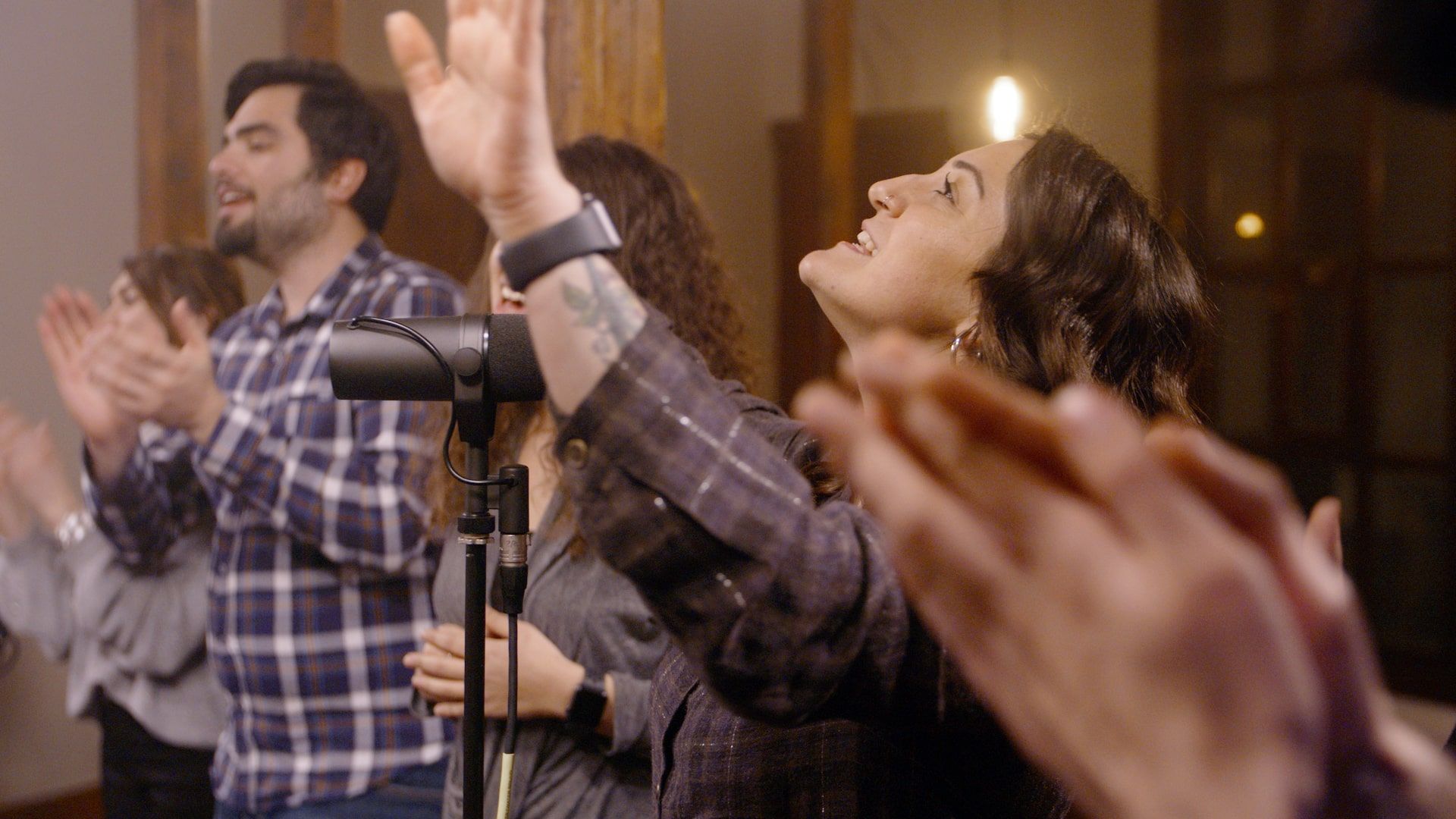 A group of young people singing gospel on stage at church. 