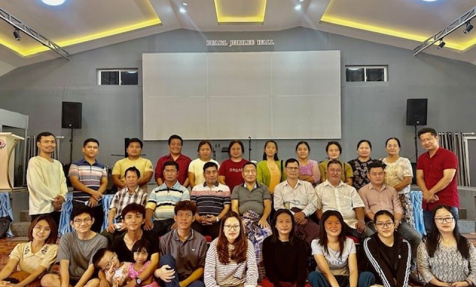 A group of people having their photo taken at church 