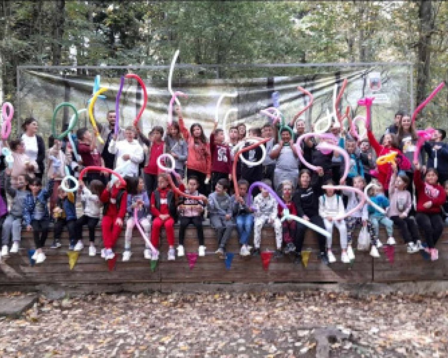 A large group of kids smiling for the photo. 