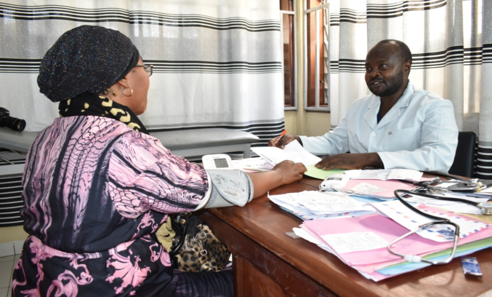 two people sitting in an office sharing documents 